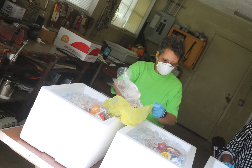 RHA Female Staff member packaging grab and go meals 