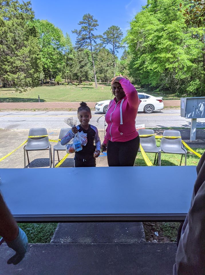 Grab and Go meal participants with hand over head