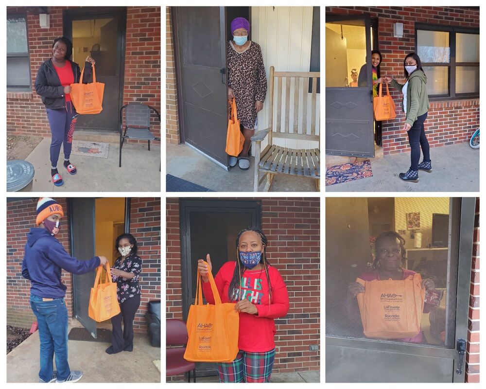 Staff handing out covid19 supply bag to residents 