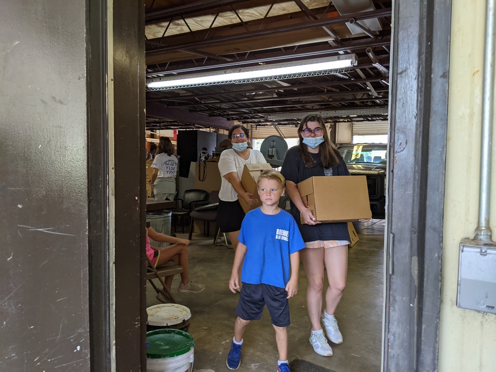 youth volunteers with boxes walking