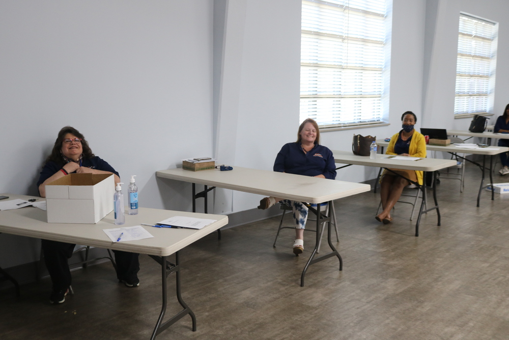 Annual Meeting Employees sitting behind desk