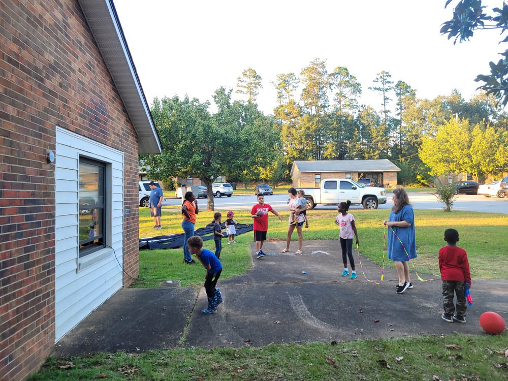 Sparkman Movie Night youth outside in yard playing games