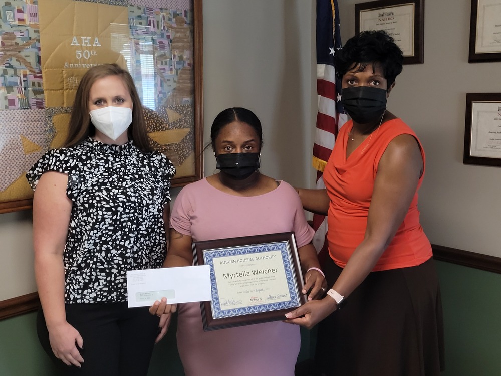 FSS Myrteila receiving award from CEO Sharon Tolbert and Rachel Harris