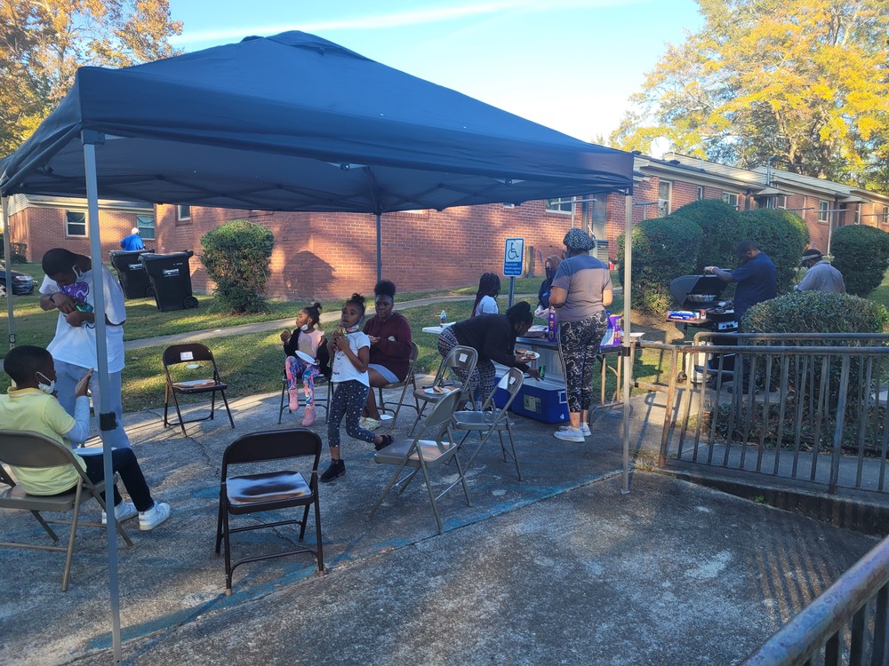 RHA Tailgate residents under blue tent