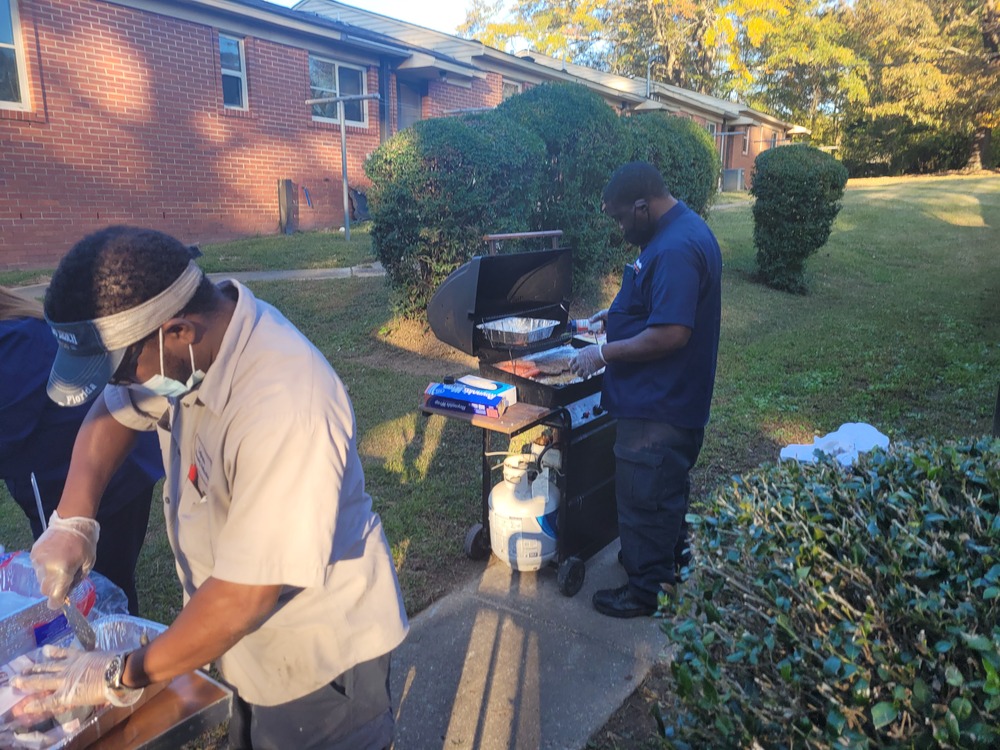 RHA Tailgate maintenance staff grilling food