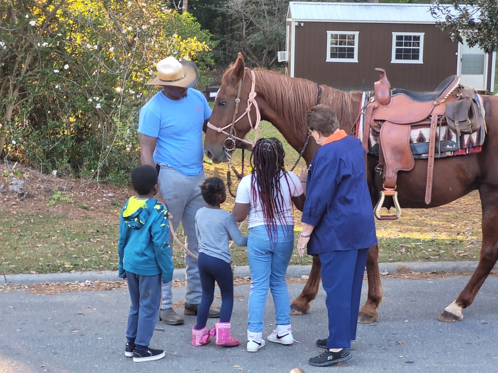 RHA Tailgate youth and two adults looking at horse