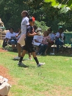 Juneteenth 2022 Celebration adult male and young male walking in opposite directions