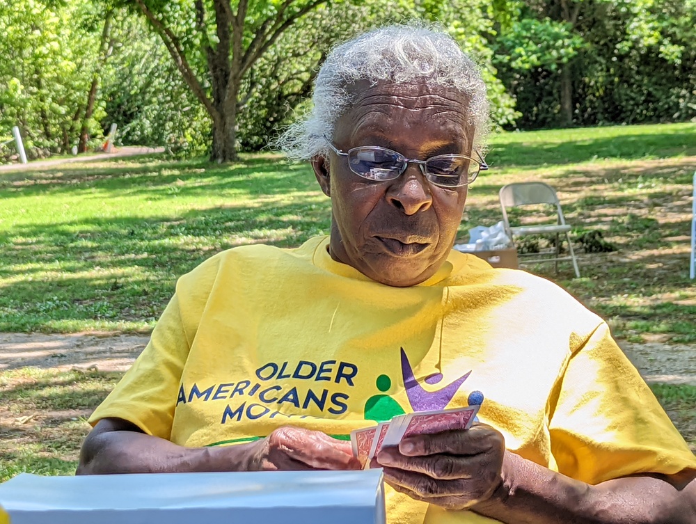 Older female residents sitting at table looking at her phone