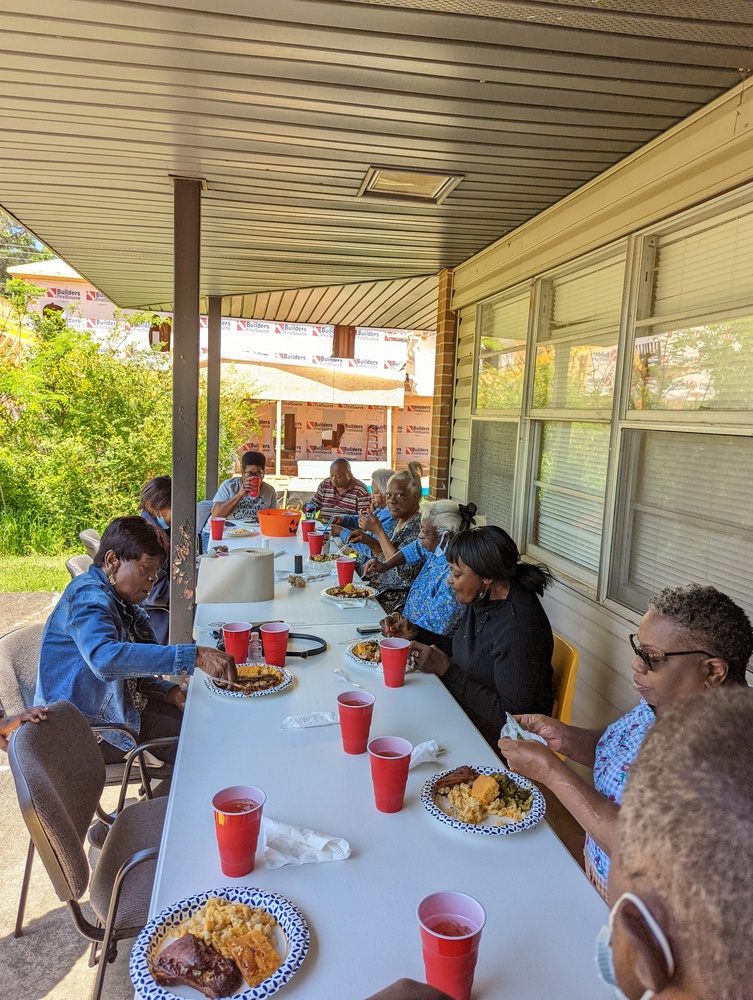 Group of Wonderful Wednesday participants eating at a long table