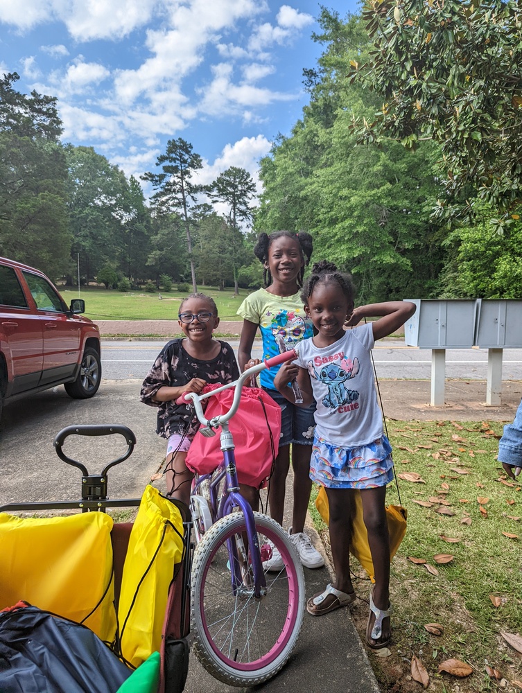 Girl youth hanging out near supplies with bicycle