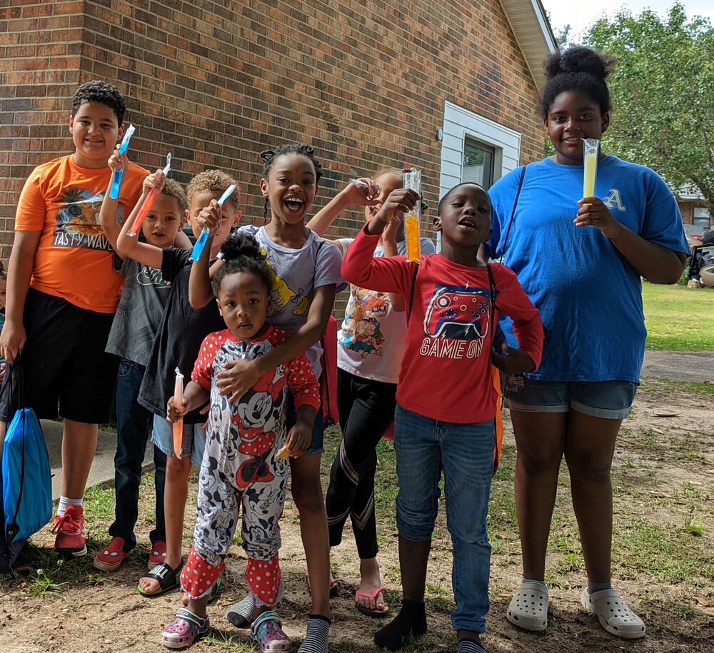 Youth residents grouped eating popsicles