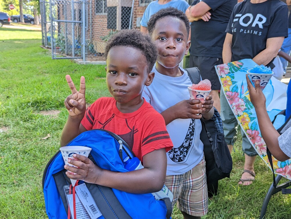 AHA Back to School event young boys with new backpacks and snowcones 