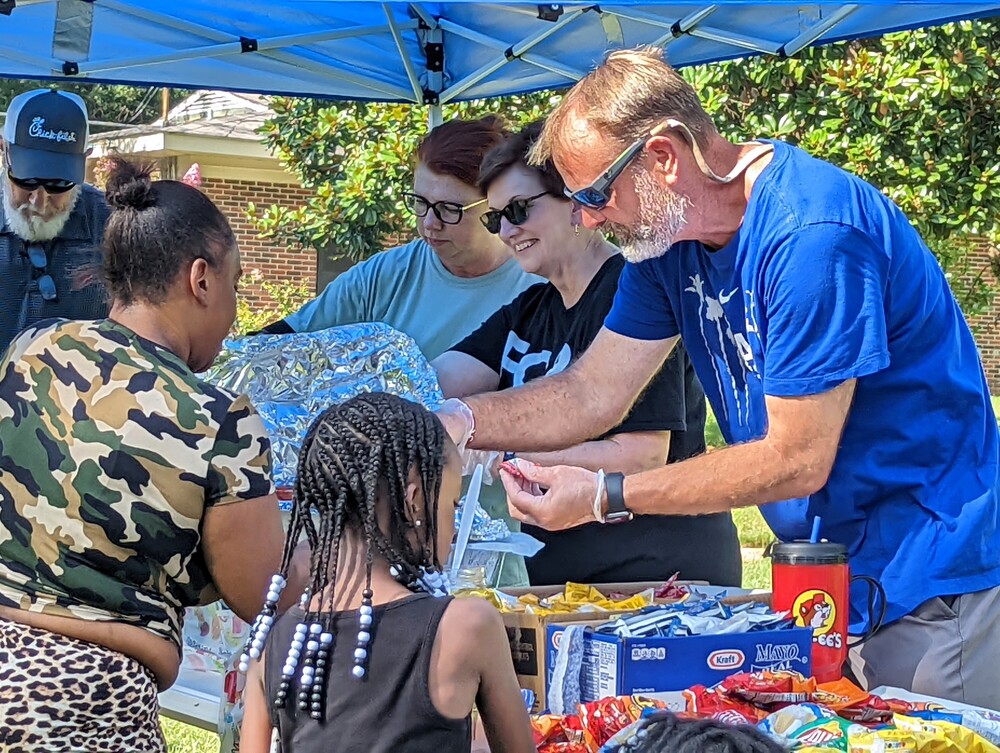 AHA Back to school youth receiving snacks from vendor table