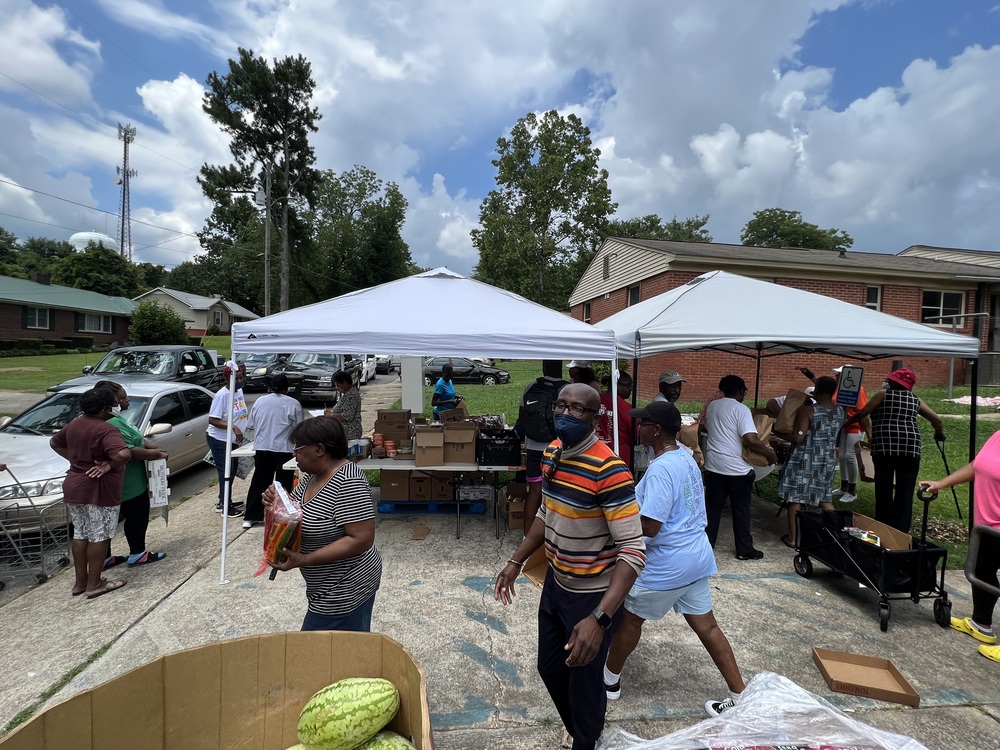 RHA Farmers Market produce distribution line and attendees