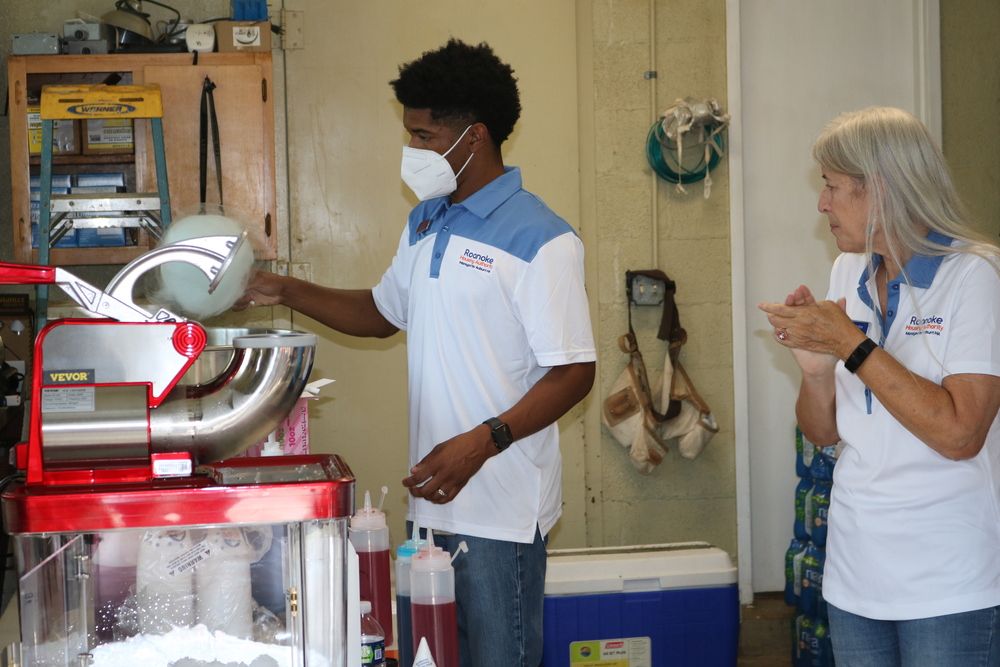 RHA Tailgate AJ Harris and Commissioner using the popcorn machine