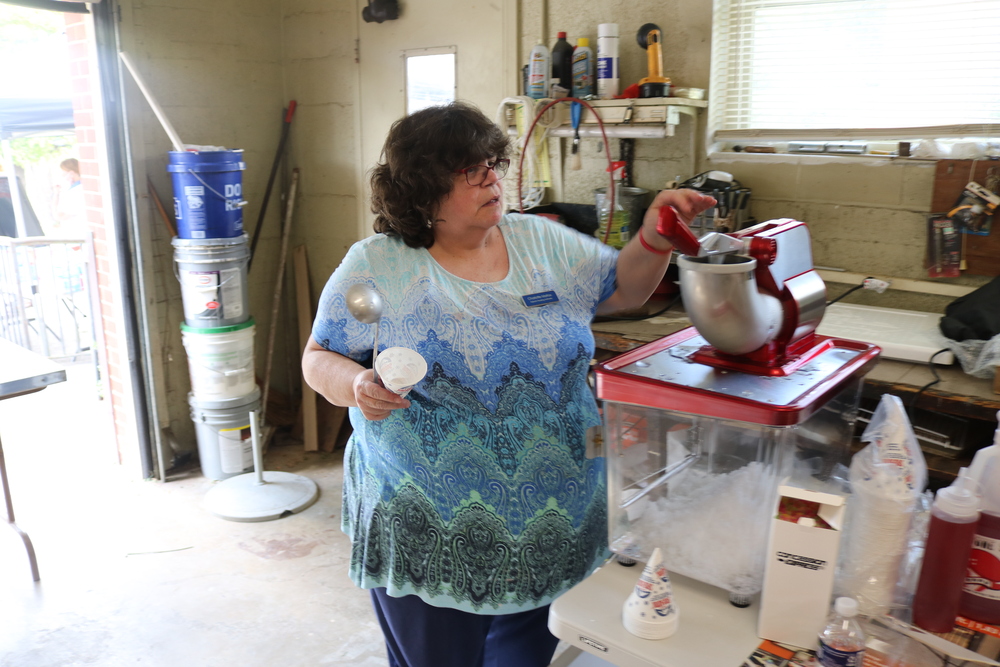 RHA Tailgate Charlotte Mattox in the kitchen holding cup