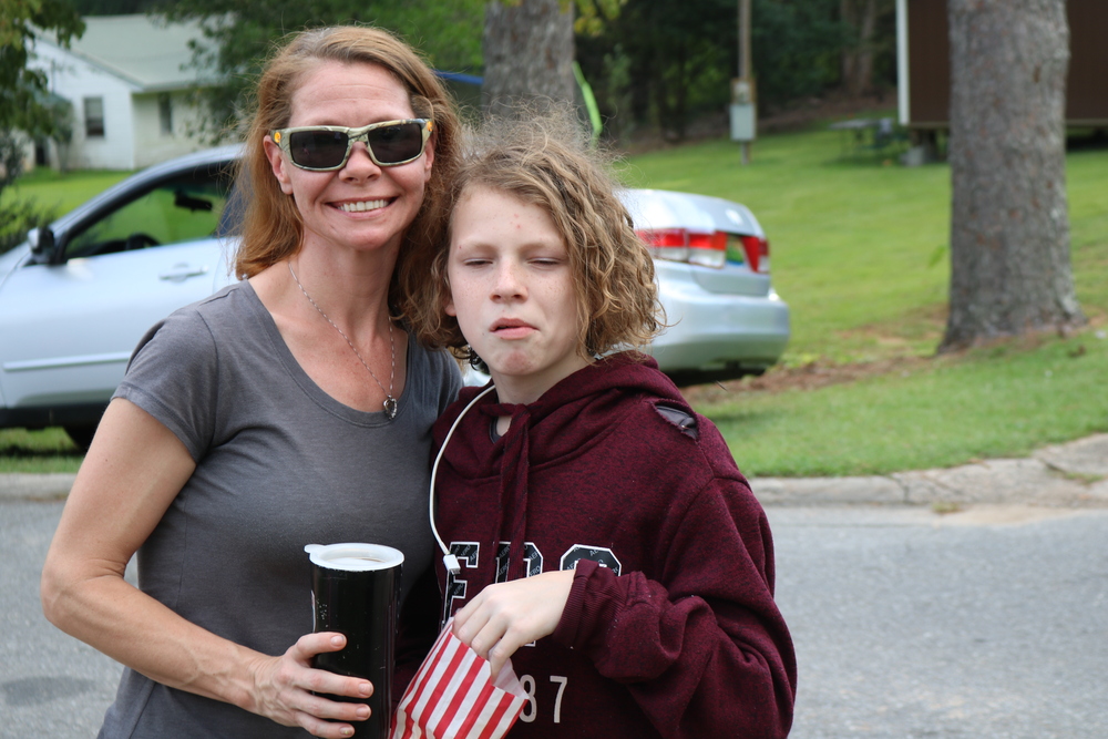 RHA Tailgate lady and son eating popcorn looking at camera