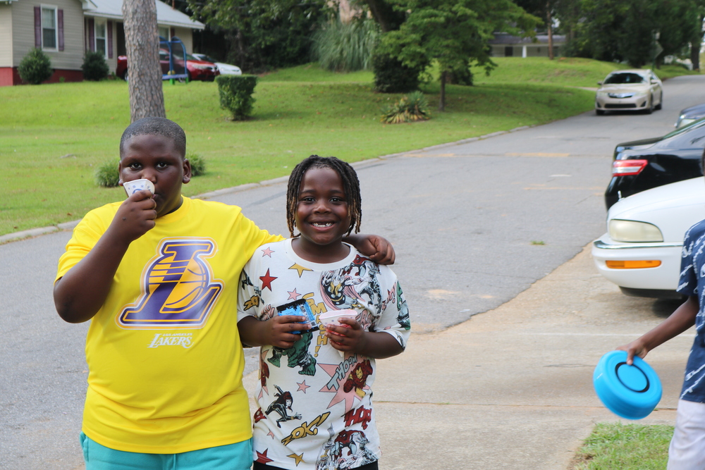 RHA Tailgate two boys smiling at eating snowcones