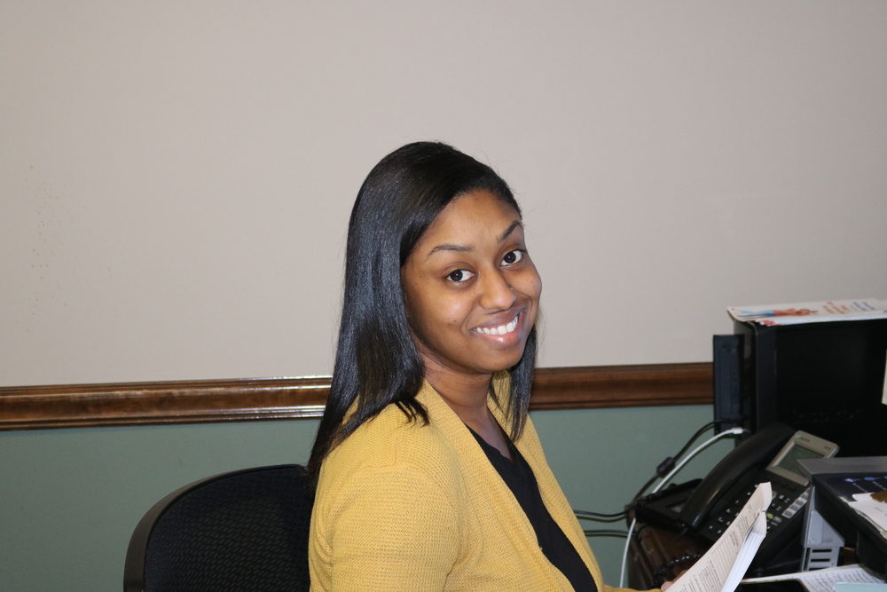 Dominique Moore sitting at a desk