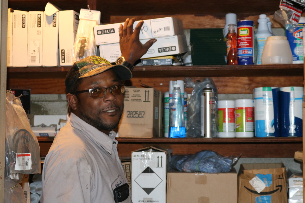 Kelvin Whitlow.in maintenance uniform with hat and award