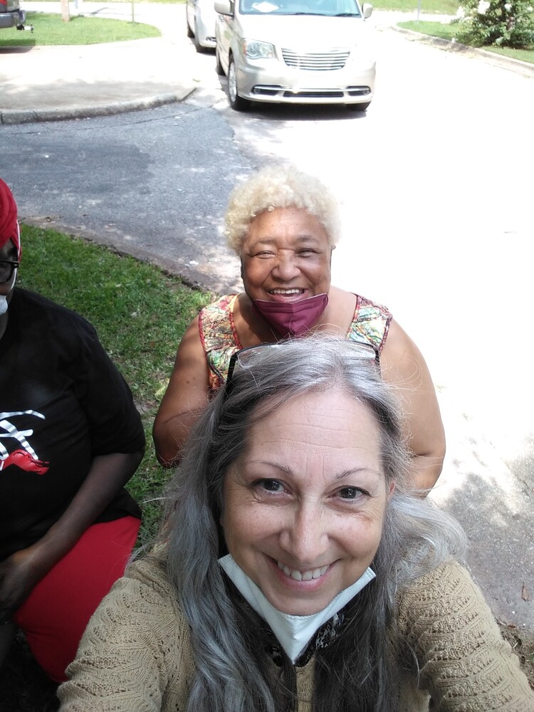 Farmers Market staff and volunteer pose for selfie