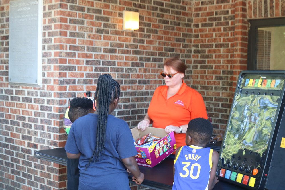 LaFayette Tailgate party staff distributing snacks to kids