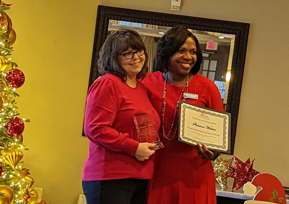 Sharon Tolbert presenting plaque to Shannon Walters for employee anniversary