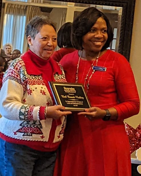 Sharon Tolbert presenting plaque to Beth Redding for employee anniversary