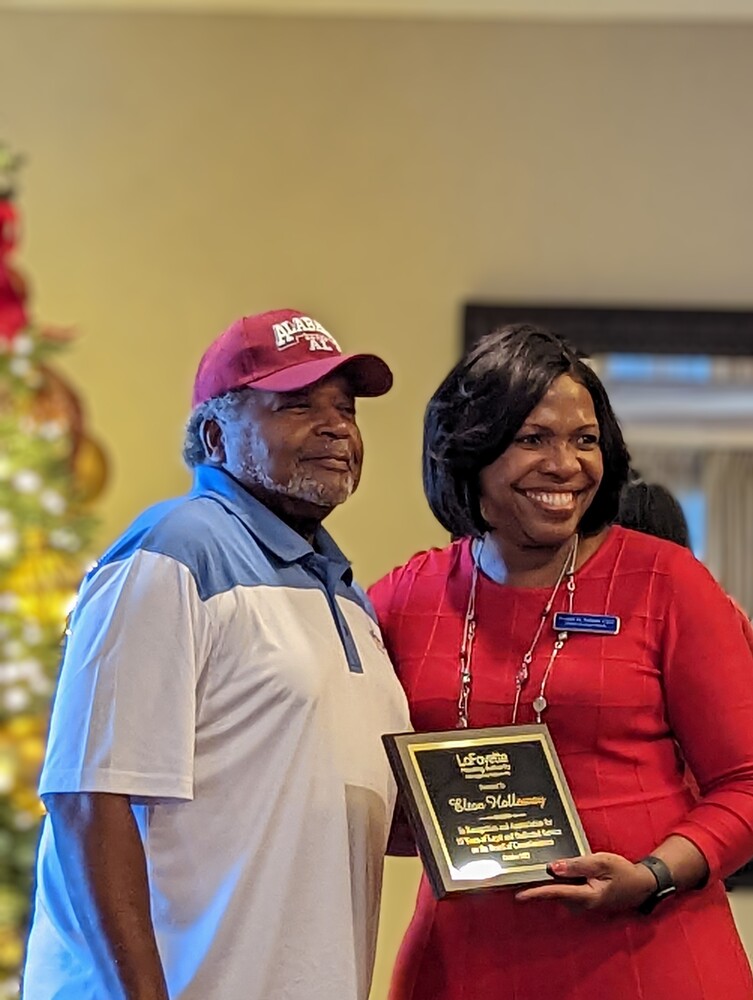 Commissioner Holloway receiving plaque from CEO Tolbert