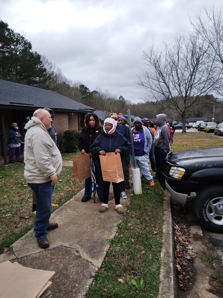 LaFayette Farmers Market residents standing in line with paper bags