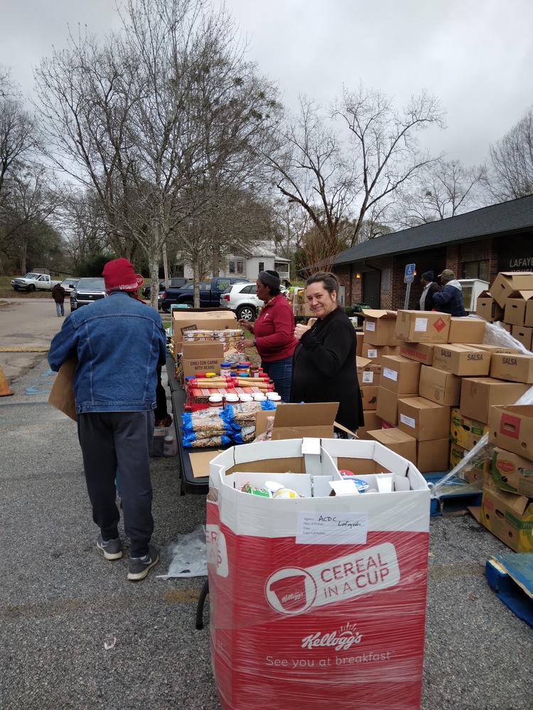 LaFayette Farmers Market people getting goods from table 