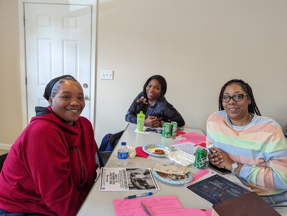 East Park Mentoring moms attendees at table with food and activities