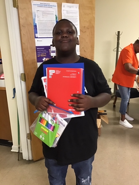 Boy holding school supplies