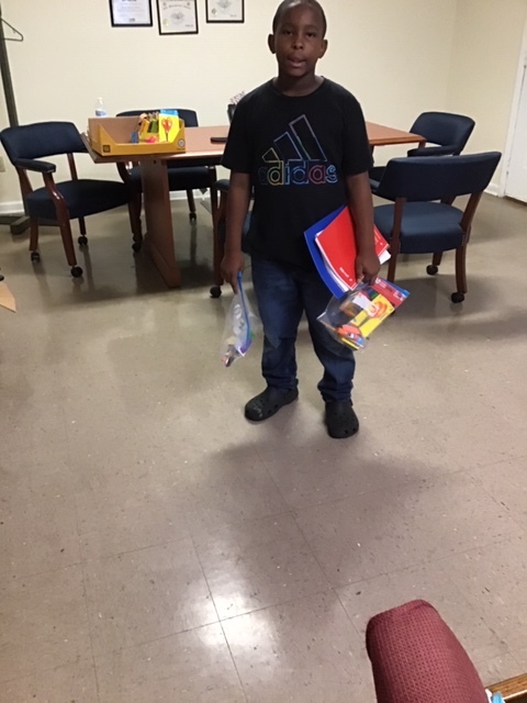 Young boy with school supplies