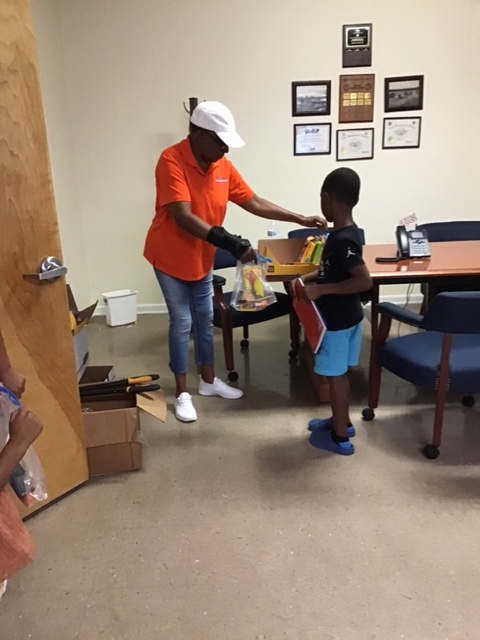 Young boy receiving school supplies