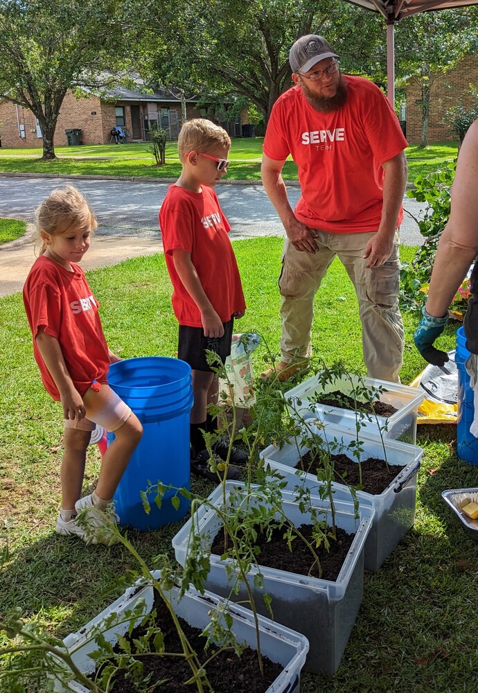 AHA Resident Service -Serve-volunteers outside with planters