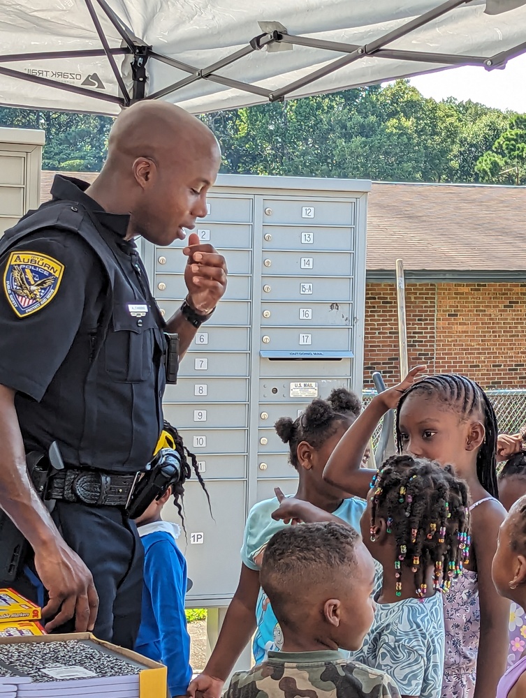 AHA Resident Service -Ridgecrest Back 2 School police officer with youth