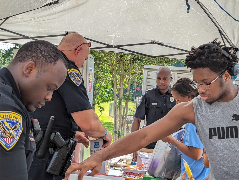 AHA Resident Service -Ridgecrest Back 2 School- police officers handing out snacks