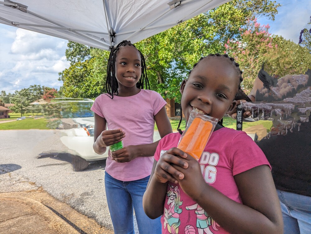 AHA Resident Service -Ridgecrest Back 2 School youth resident eating popsicle