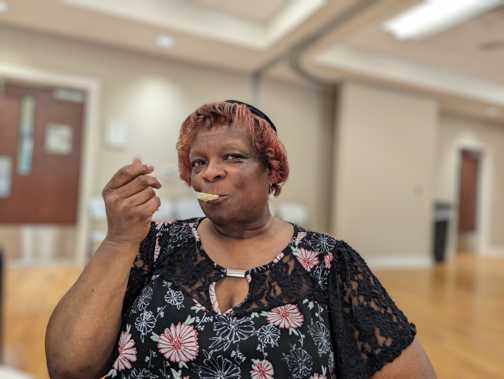 AHA Resident Service -Sr. Ice cream social older lady with spoon to her mouth