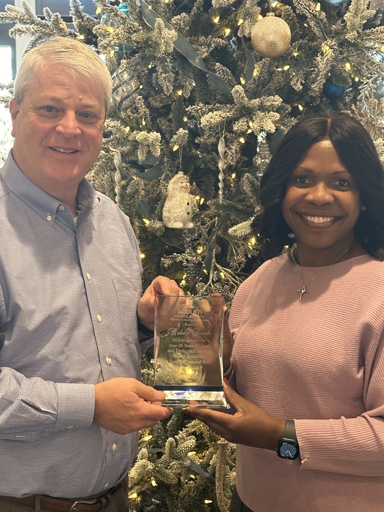 Commissioner Robert Smith receiving his 20 year anniversary plaque from CEO Sharon Tolbert