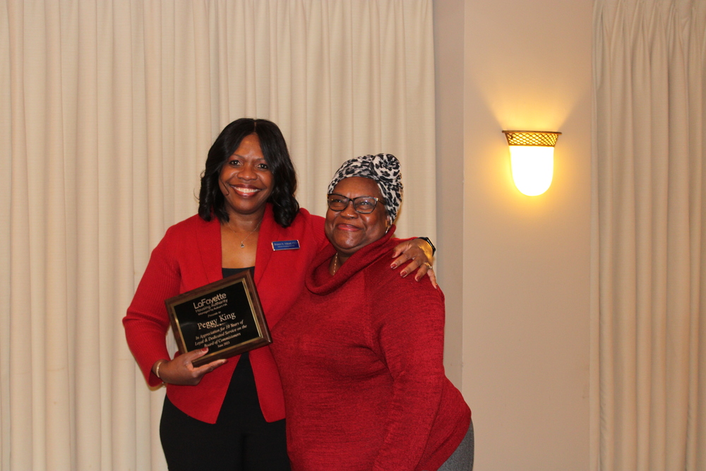 Commissioner Peggy King receiving her 10 year anniversary plaque from CEO Sharon Tolbert