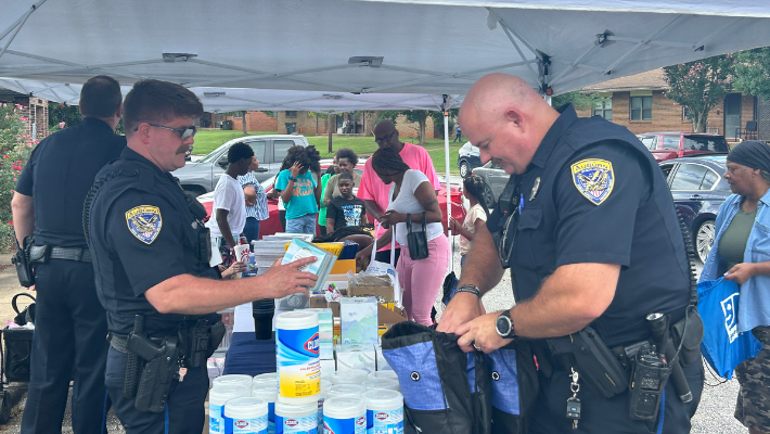 Auburn Police filling tote bags at back to school giveaway