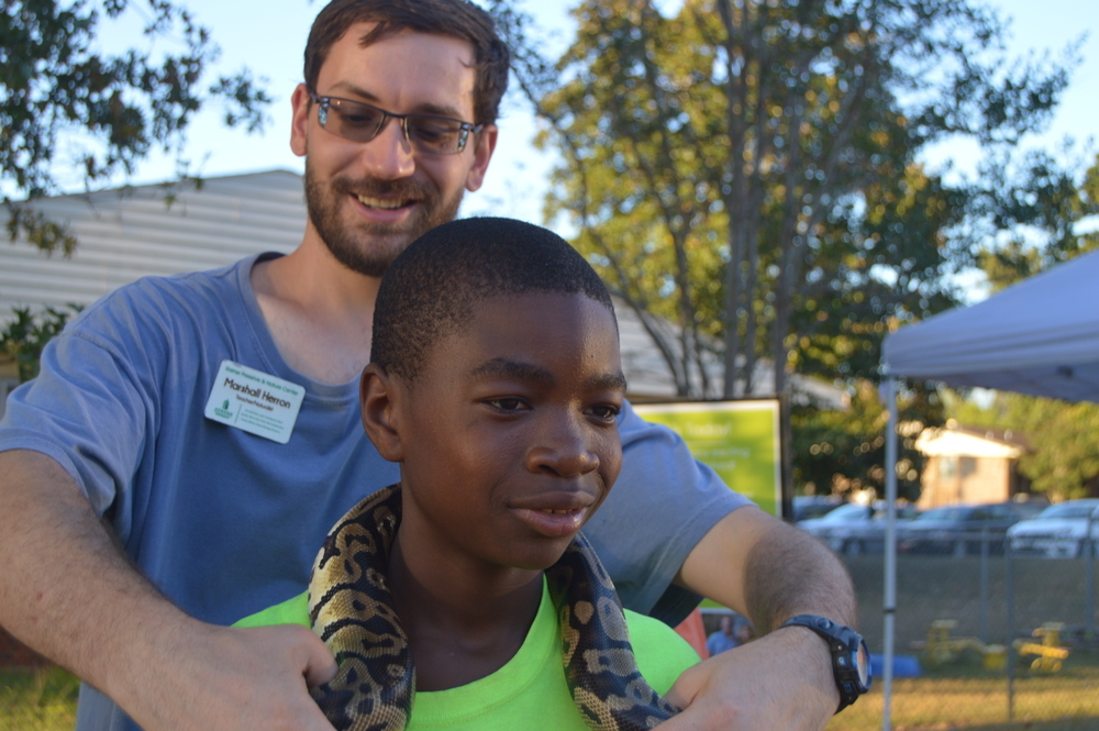 Auburn University Volunteer with reptile on child