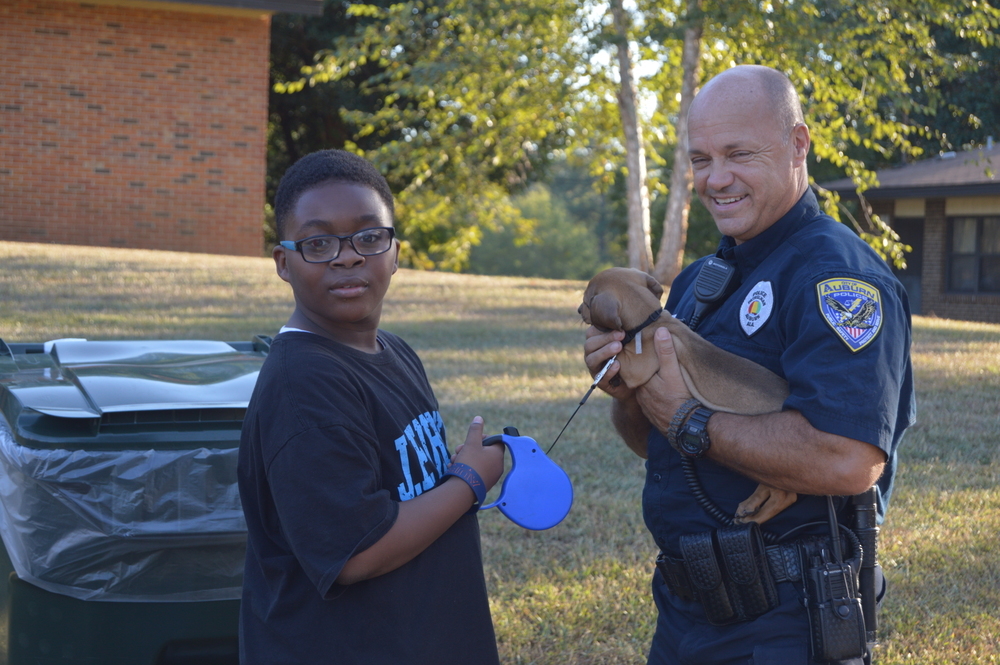 Auburn Police Officer with resident puppy