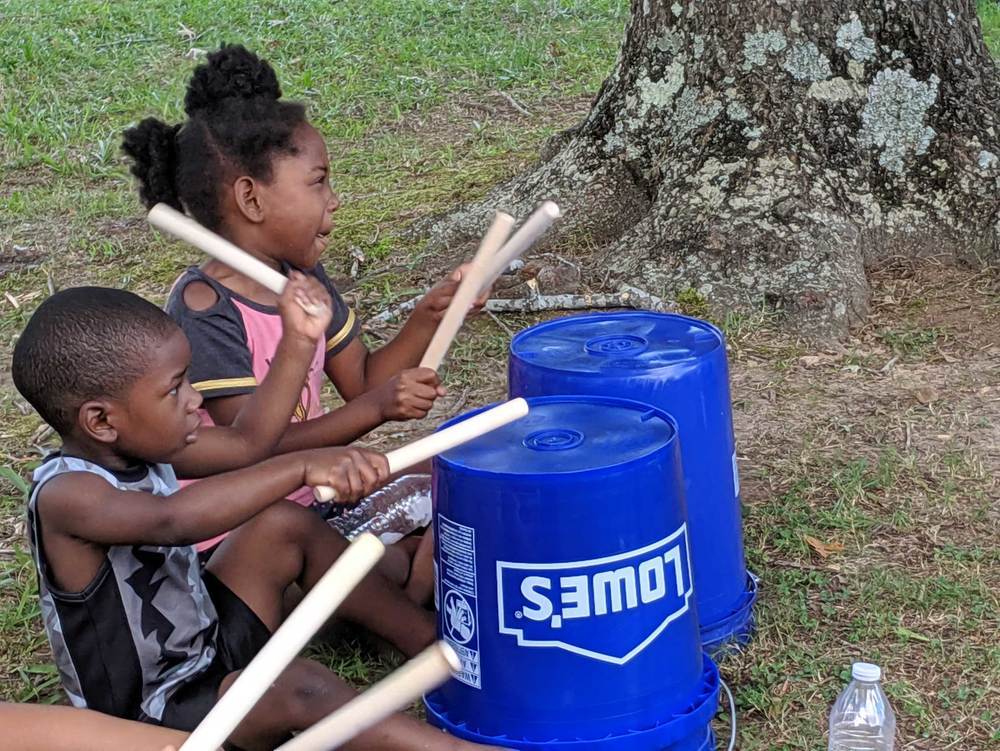 Kids playing drums at summer feeding