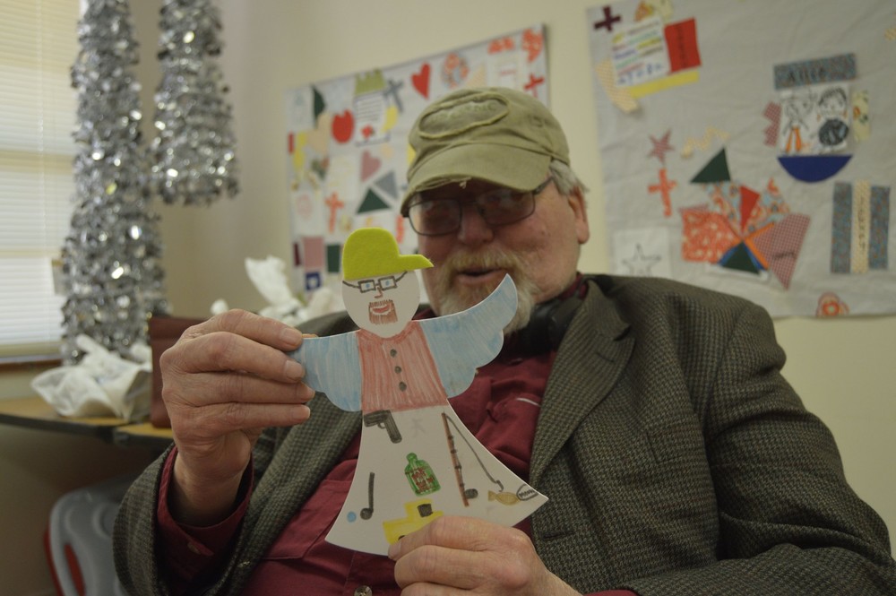 male resident showing off his christmas tree craft