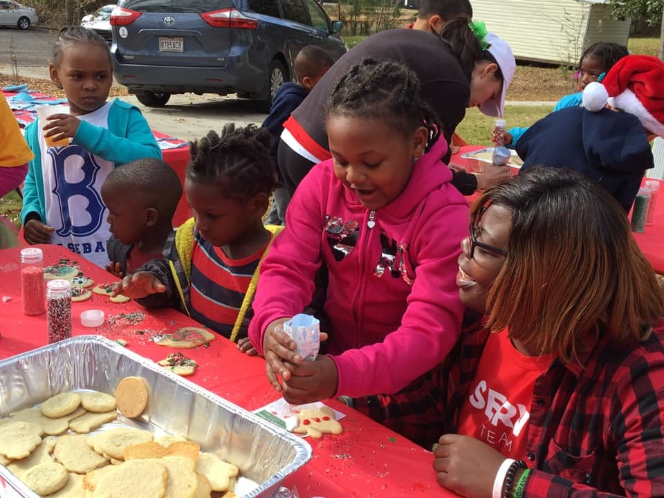 youth residents outside decorating cookies