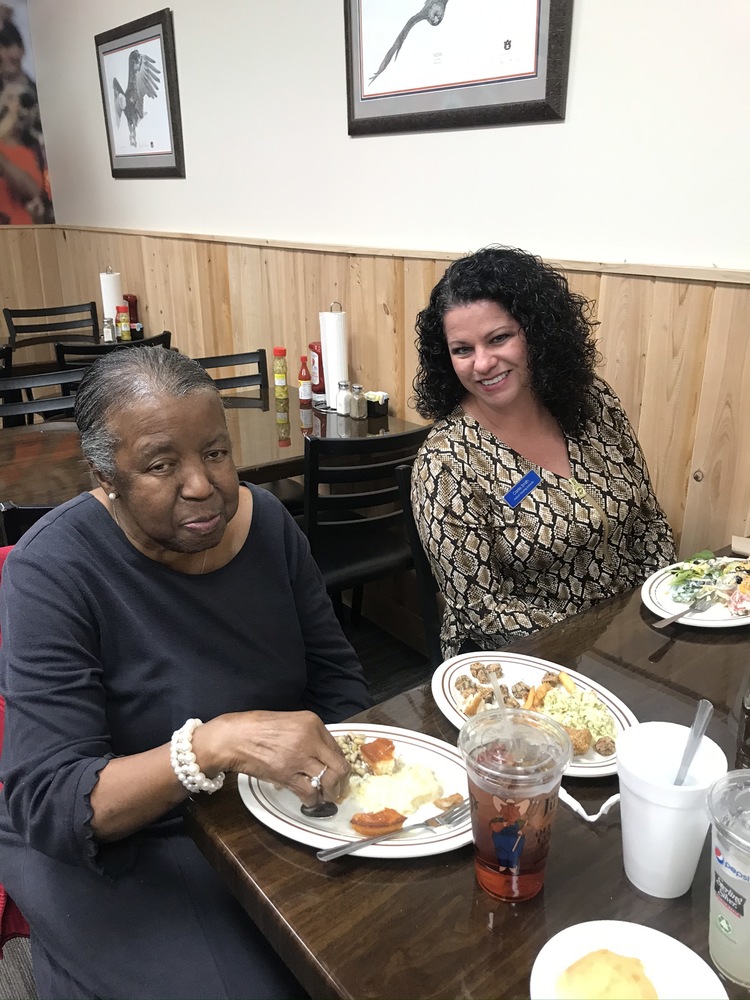 Senior resident and staff posing at senior luncheon holiday in lha newsletter