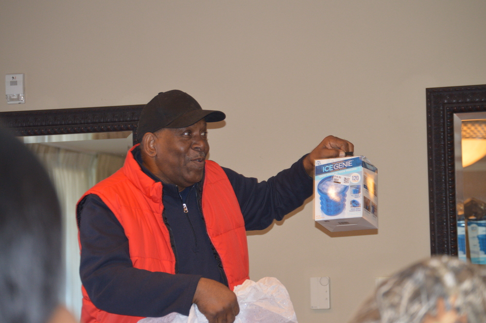Man in a vest holding an opened Christmas gift